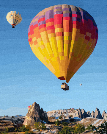 Barwne balony nad skalistym pejzażem